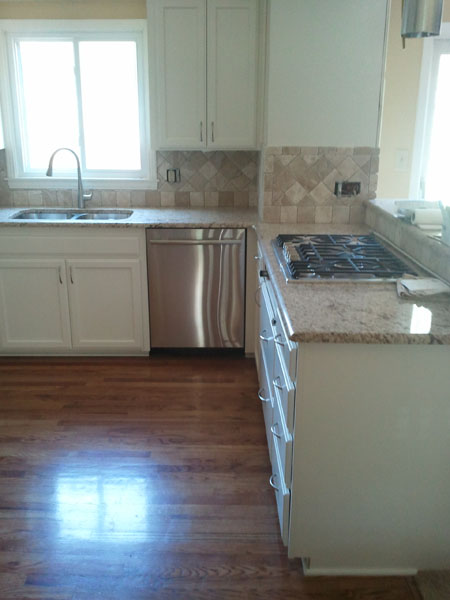 kitchen with white cabinets and giallo ornamental custom fabricated granite countertops