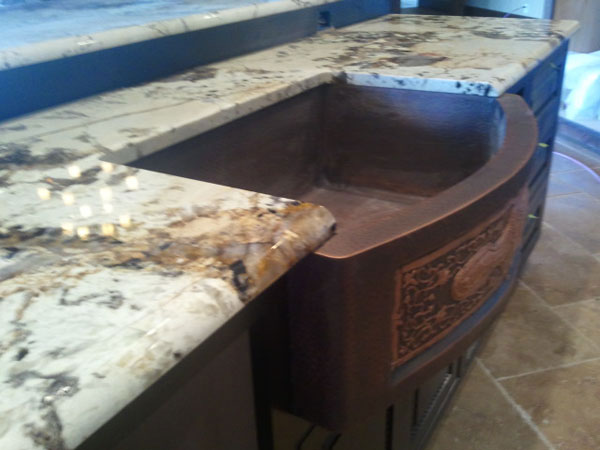patagonia granite countertops with hammered copper farm sink